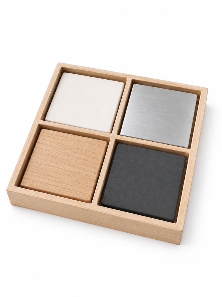 Four material samples in a wooden tray.