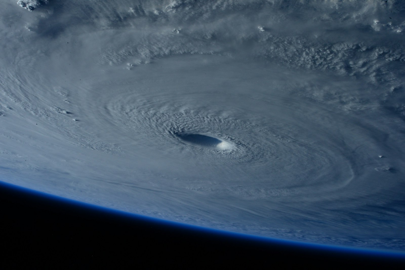 A hurricane photographed from orbit, with the eye of the storm near the center.